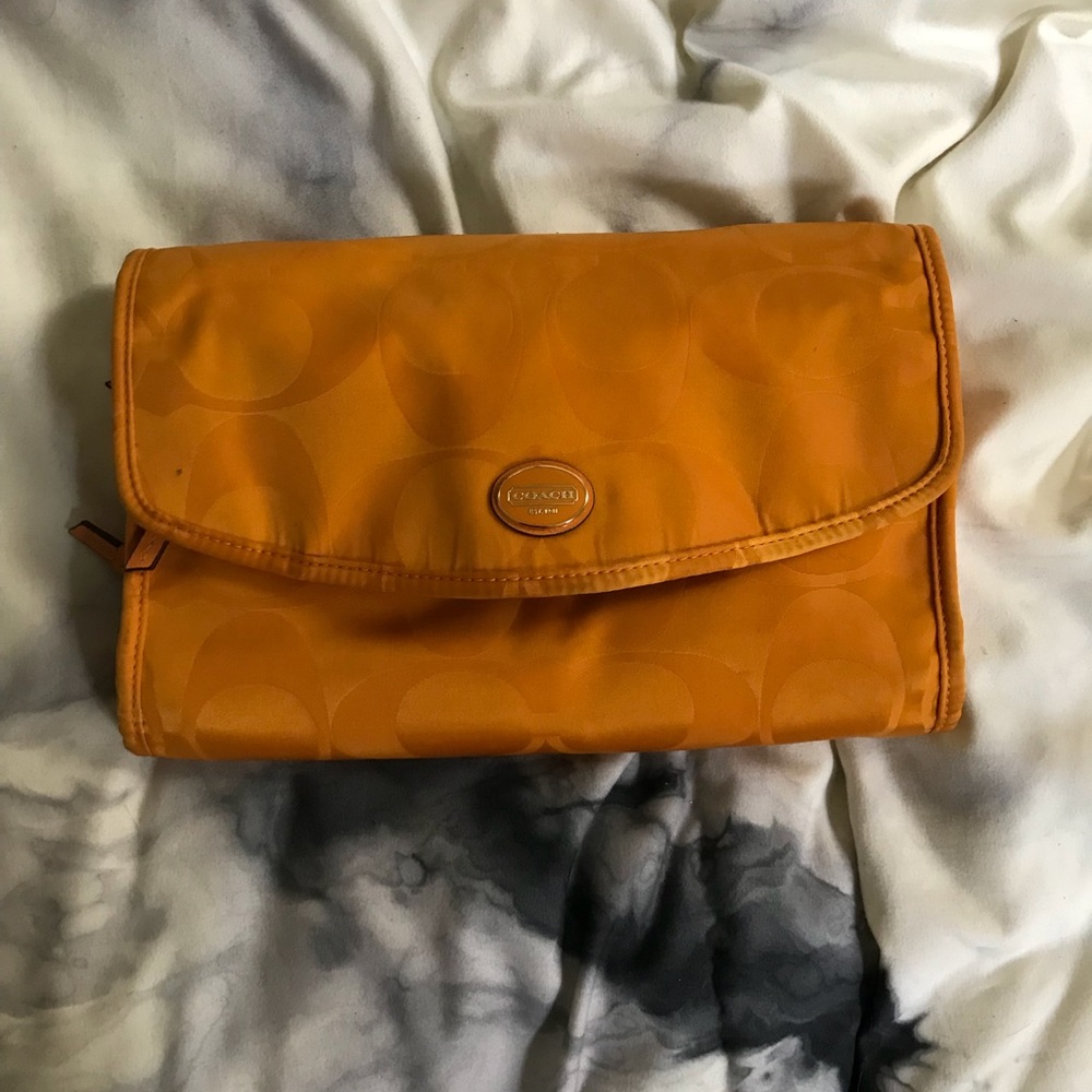Orange coach toiletry bag